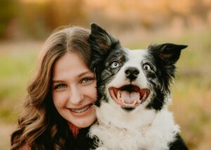 Woman and dog smiling looking at camera