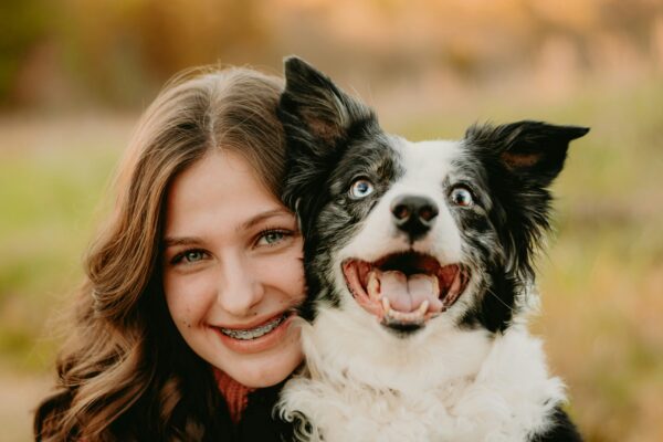 Woman and dog smiling looking at camera